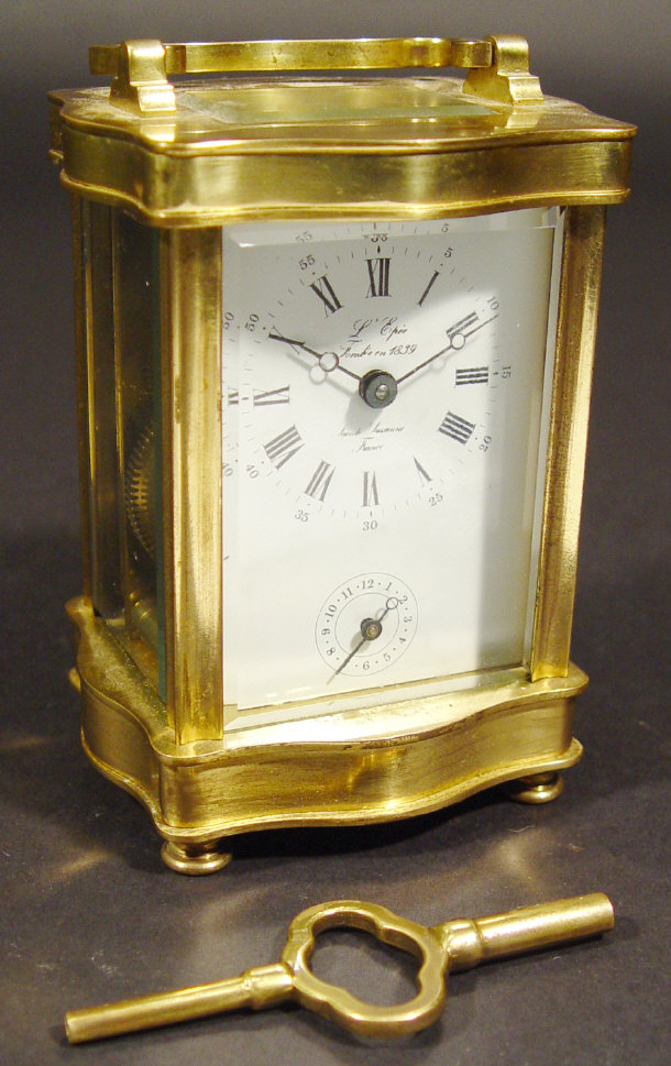 Appraisal: Brass carriage clock the serpentine fronted case containing a painted