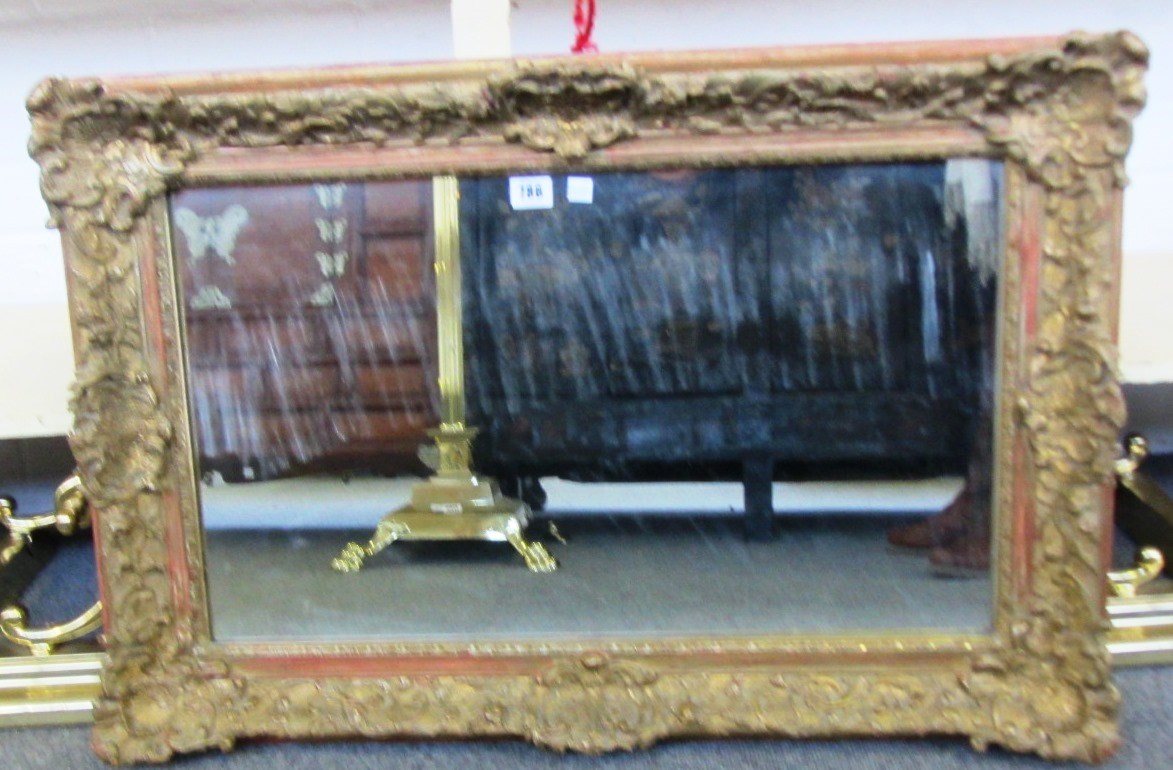 Appraisal: A gilt framed rectangular wall mirror with shell moulded corner