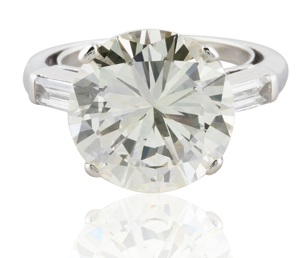 Appraisal: A CT ROUND BRILLIANT AND TRAPEZOID DIAMOND RING A CT