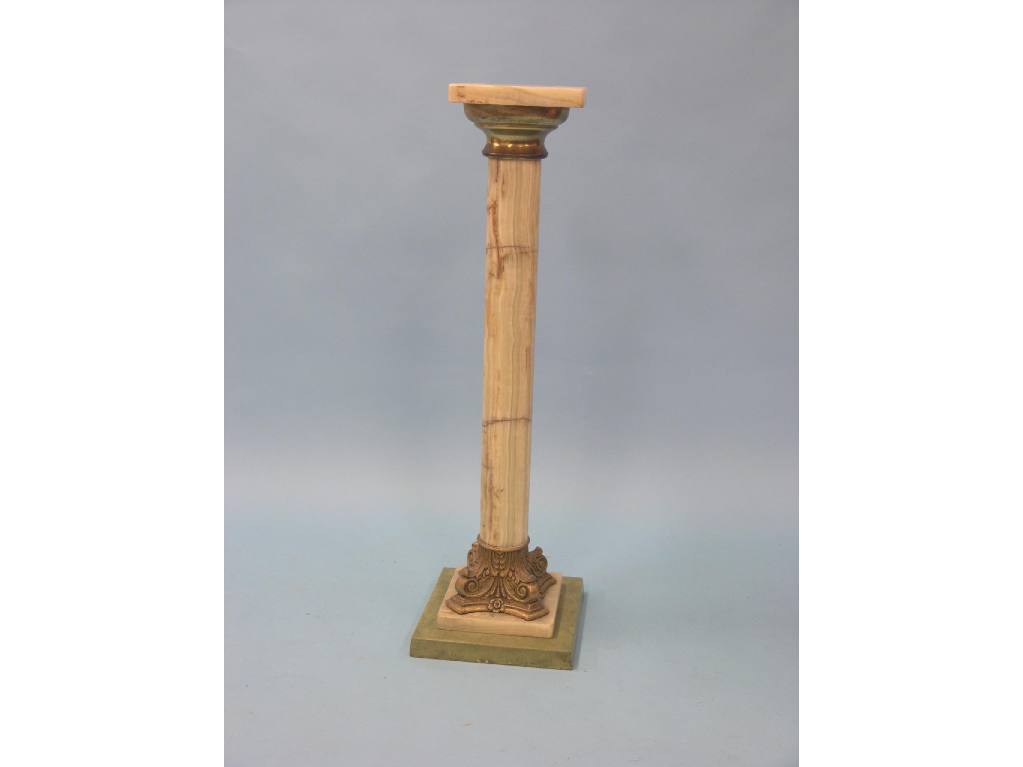 Appraisal: An onyx torchere stand column issuing from gilt-metal corinthian plinth