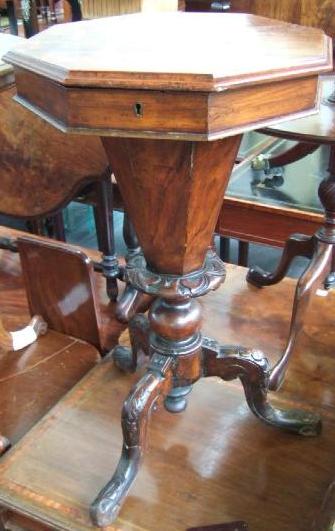 Appraisal: A Victorian walnut trumpet shaped sewing table the lift octagonal