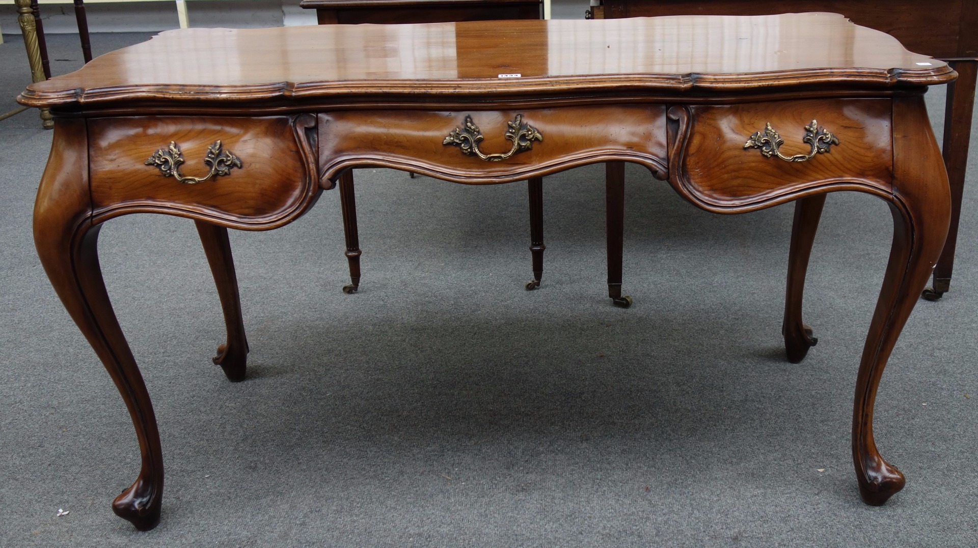 Appraisal: An th century style Continental fruitwood bureau plat the shaped