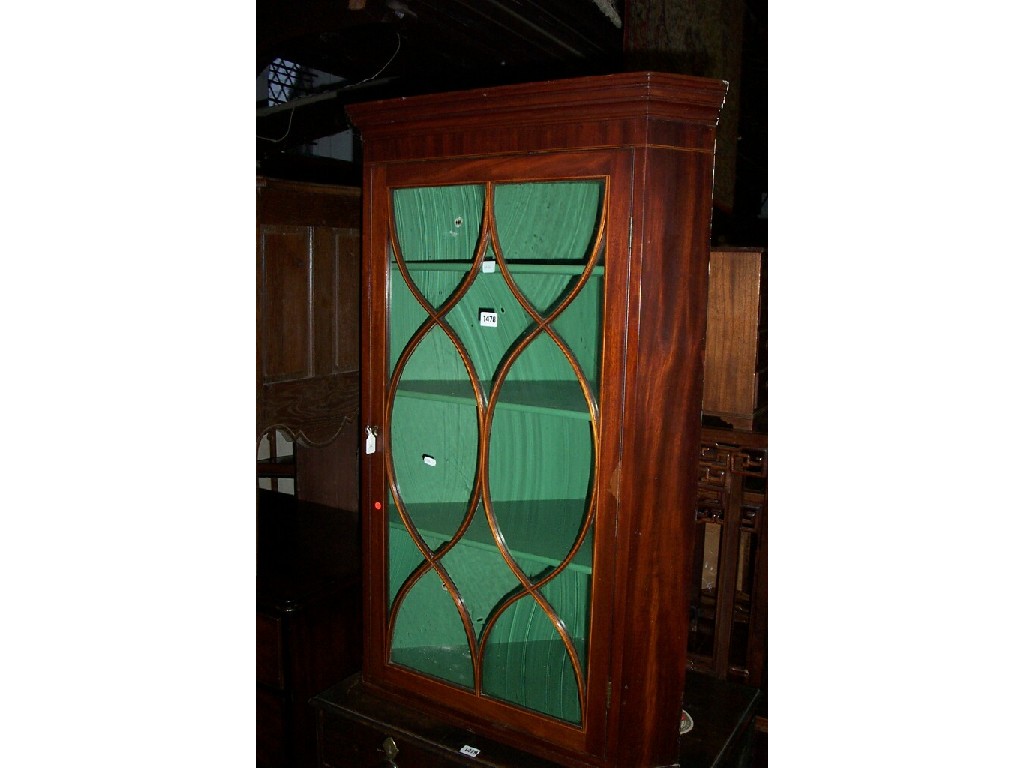 Appraisal: A Georgian mahogany hanging corner cupboard with astragal glazed panelled