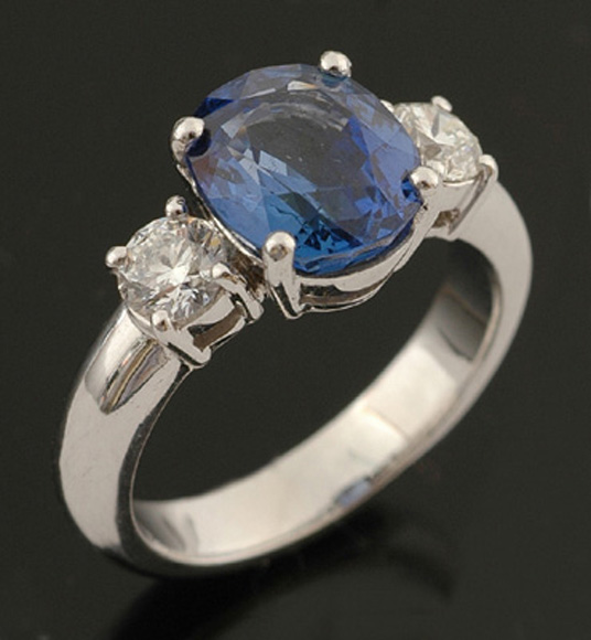 Appraisal: A three stone sapphire and diamond ring The oval cut