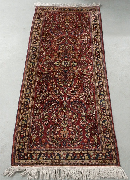 Appraisal: - Sarouk oriental hall runner with a red field and