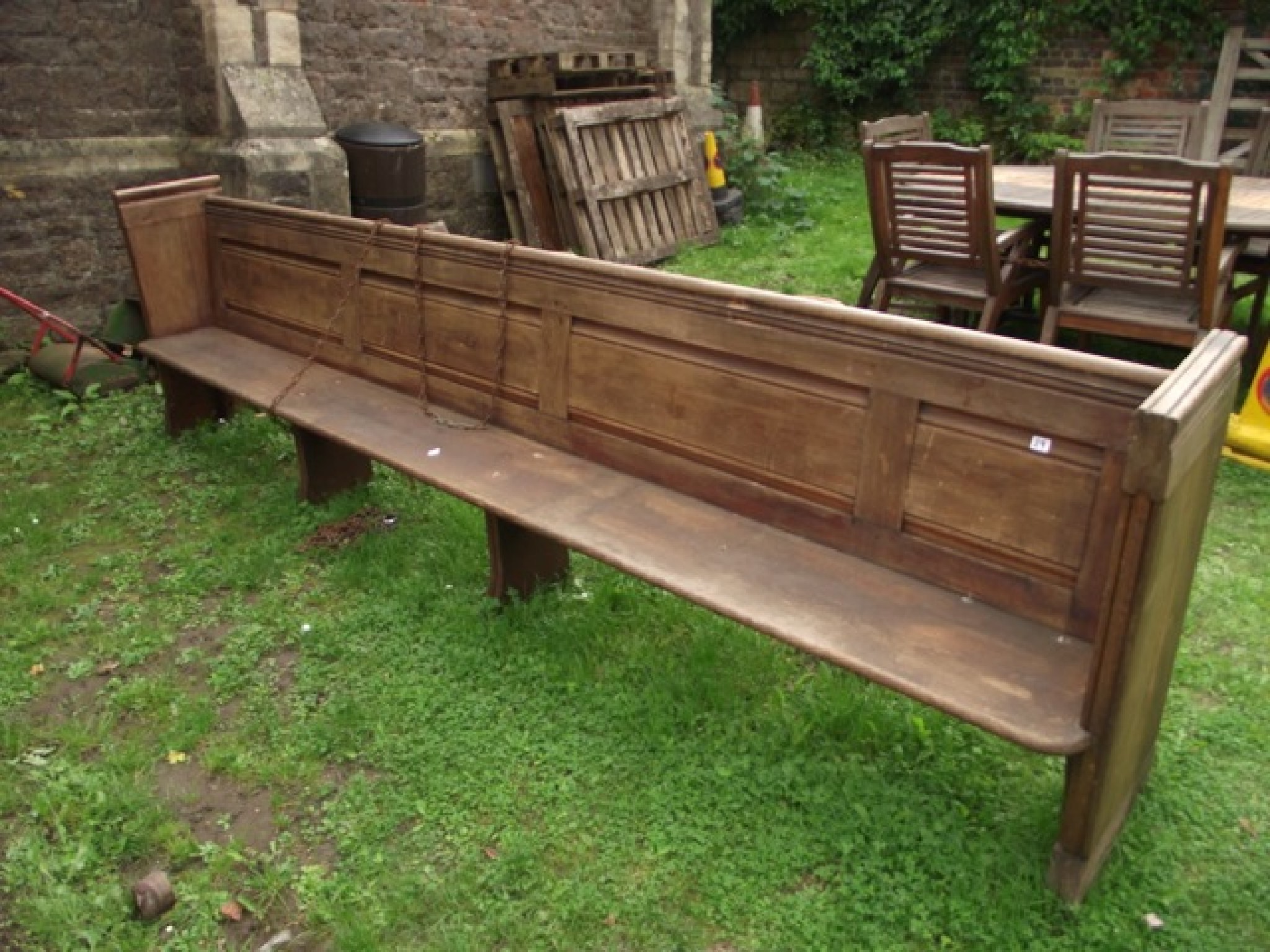 Appraisal: A reclaimed pitch pine church pew with plank seat panelled