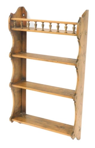 Appraisal: A Victorian pine hanging wall shelf with a galleried upper