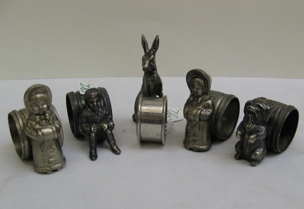 Appraisal: GROUP OF VICTORIAN STYLE FIGURAL NAPKIN RINGS of silver plate