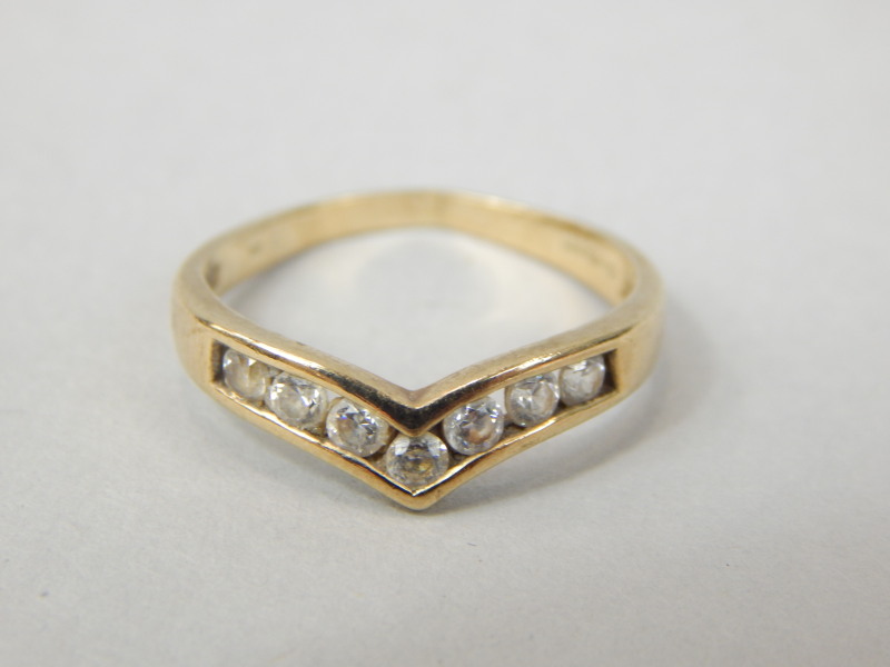 Appraisal: A ct gold dress ring set with seven CZ stones