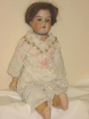 Appraisal: A German bisque shoulder head doll with blue glass sleeping