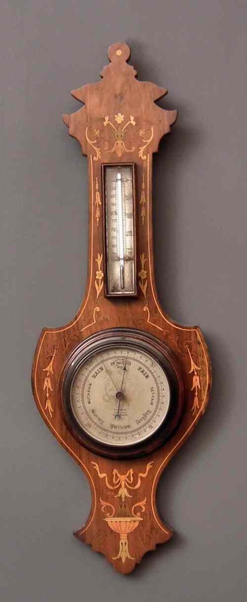 Appraisal: A late Victorian mahogany cased aneroid barometer and thermometer by