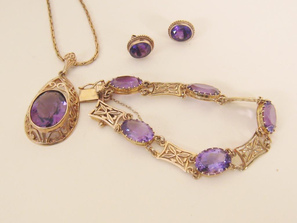 Appraisal: An Amethyst Pendant the oval shaped stone in rub-over setting