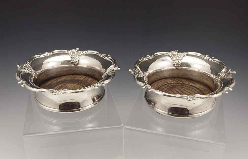 Appraisal: SILVER WINE COASTERS Pair matching wine coasters with wood bases