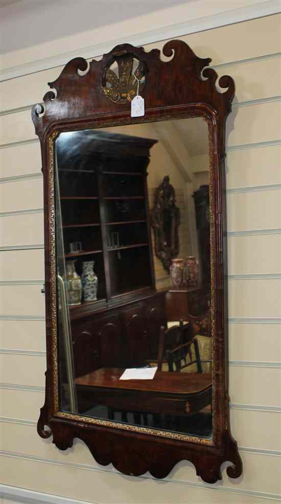 Appraisal: An th century walnut and parcel gilt fret frame mirror