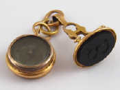 Appraisal: A French hallmarked carat gold compass and a similar fob