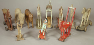 Appraisal: A collection of nine various th century wheeled toy horses