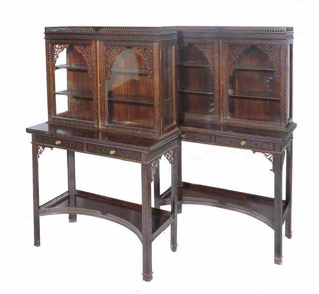 Appraisal: A PAIR OF MAHOGANY SIDE CABINETS with pierced and blind