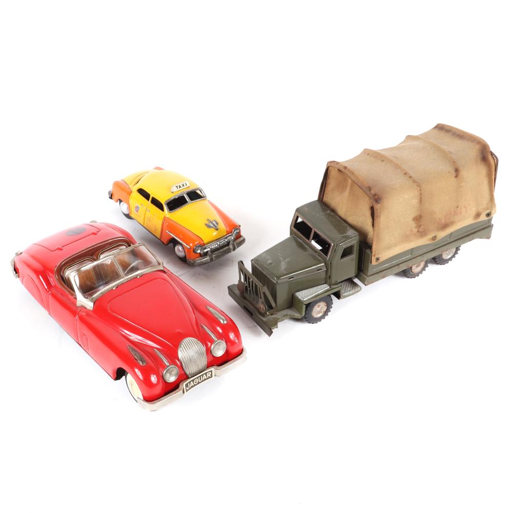 Appraisal: VINTAGE MADE IN JAPAN TIN VEHICLES ARMY TRUCK TAXI JAGUAR