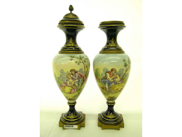 Appraisal: Pair of Sevres porcelain urns depicting romantic couples in landscape