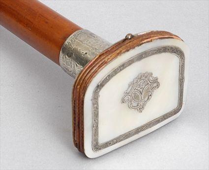 Appraisal: FRUITWOOD WALKING STICK WITH COIN PURSE HANDLE The silver-inlaid mother-of-pearl