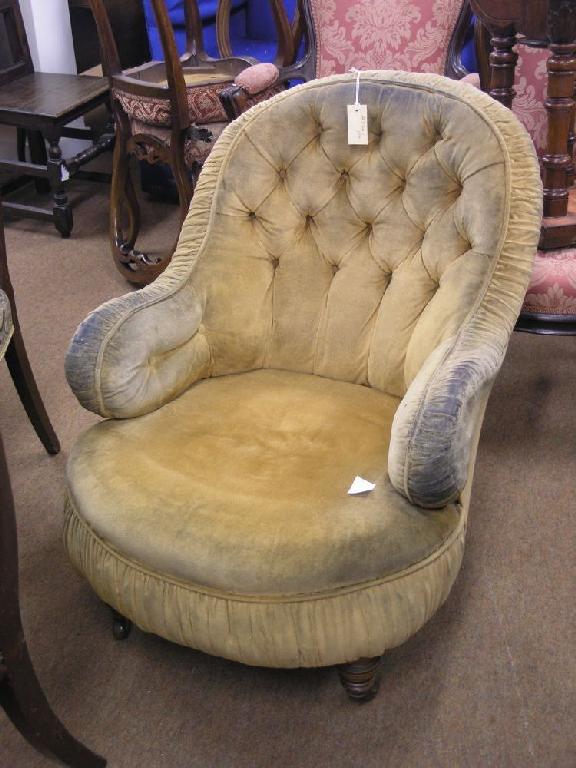 Appraisal: A Victorian upholstered salon armchair on front turned walnut legs