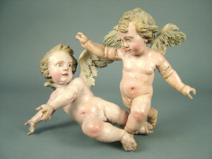 Appraisal: A pair of th century Continental carved wooden putti with