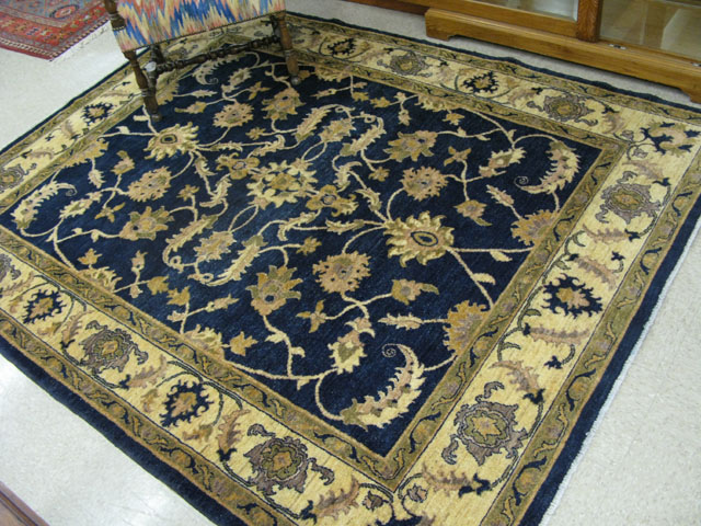 Appraisal: AN AFGHANI PERSIAN CARPET having a floral decorated dark blue