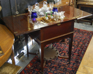 Appraisal: A metamorphic drinks cabinet the two part hinged top revealing