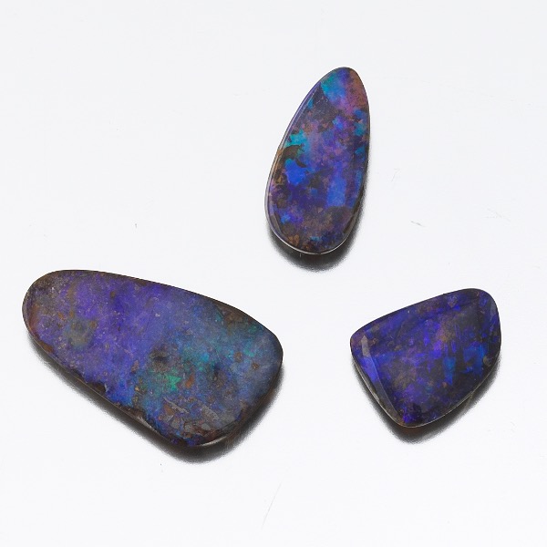 Appraisal: THREE UNMOUNTED BLACK BOULDER OPALS Three cabochon cut black boulder