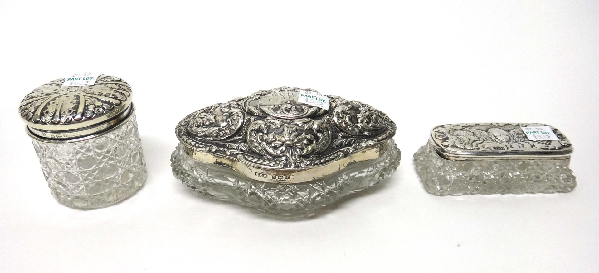 Appraisal: A silver lidded quatrefoil shaped faceted glass dressing table box