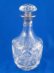 Appraisal: A silver mounted cut glass mallet shaped decanter with faceted