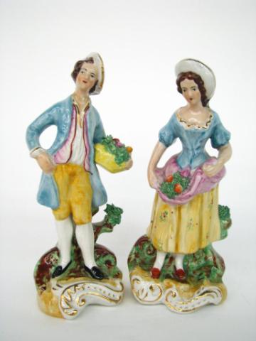 Appraisal: Two Staffordshire figurines including girl with fruit basket damage on