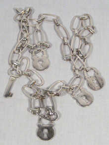 Appraisal: A silver chain belt made up of padlocks and keys