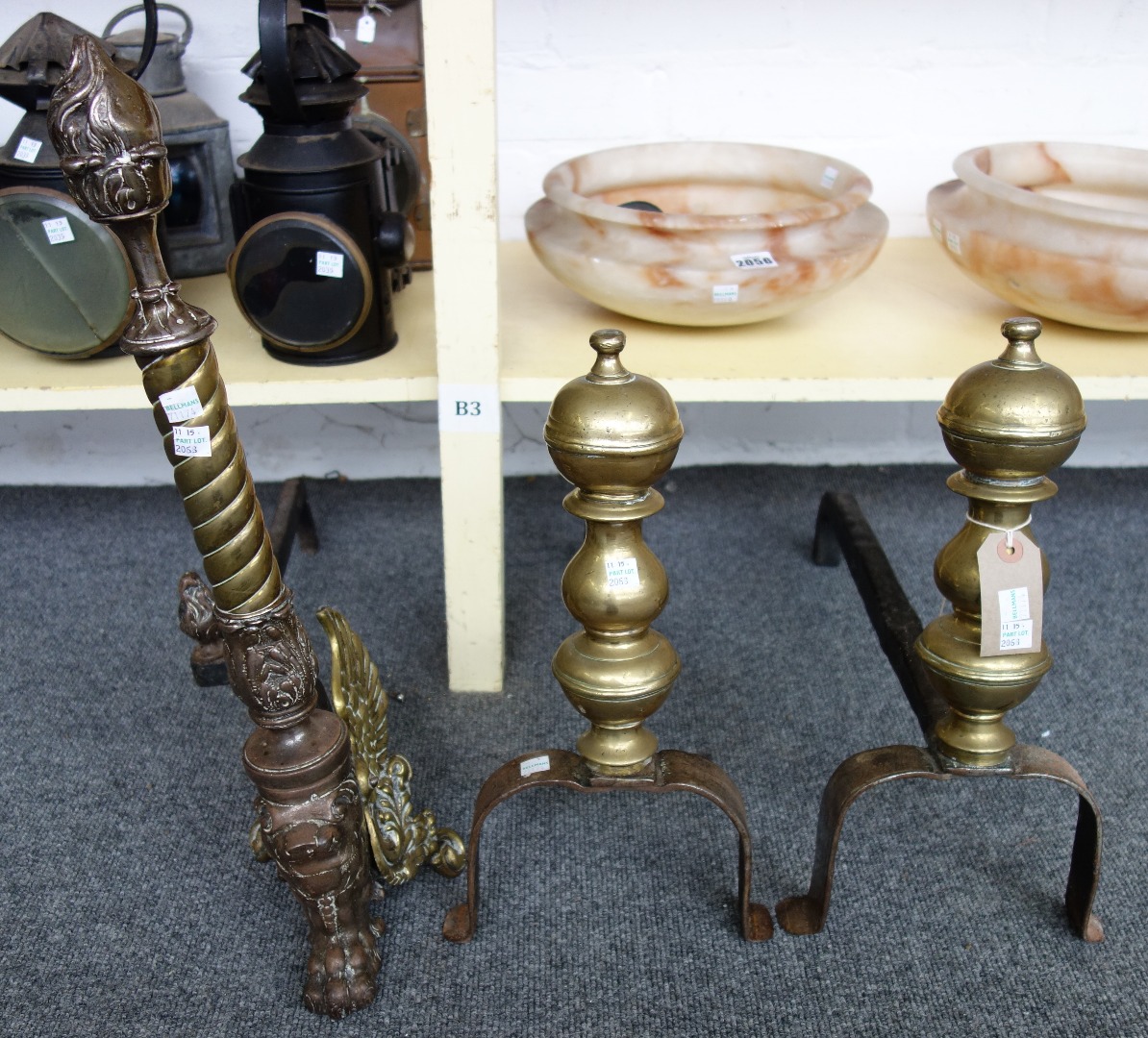 Appraisal: A pair of cast iron and brass fire dogs th