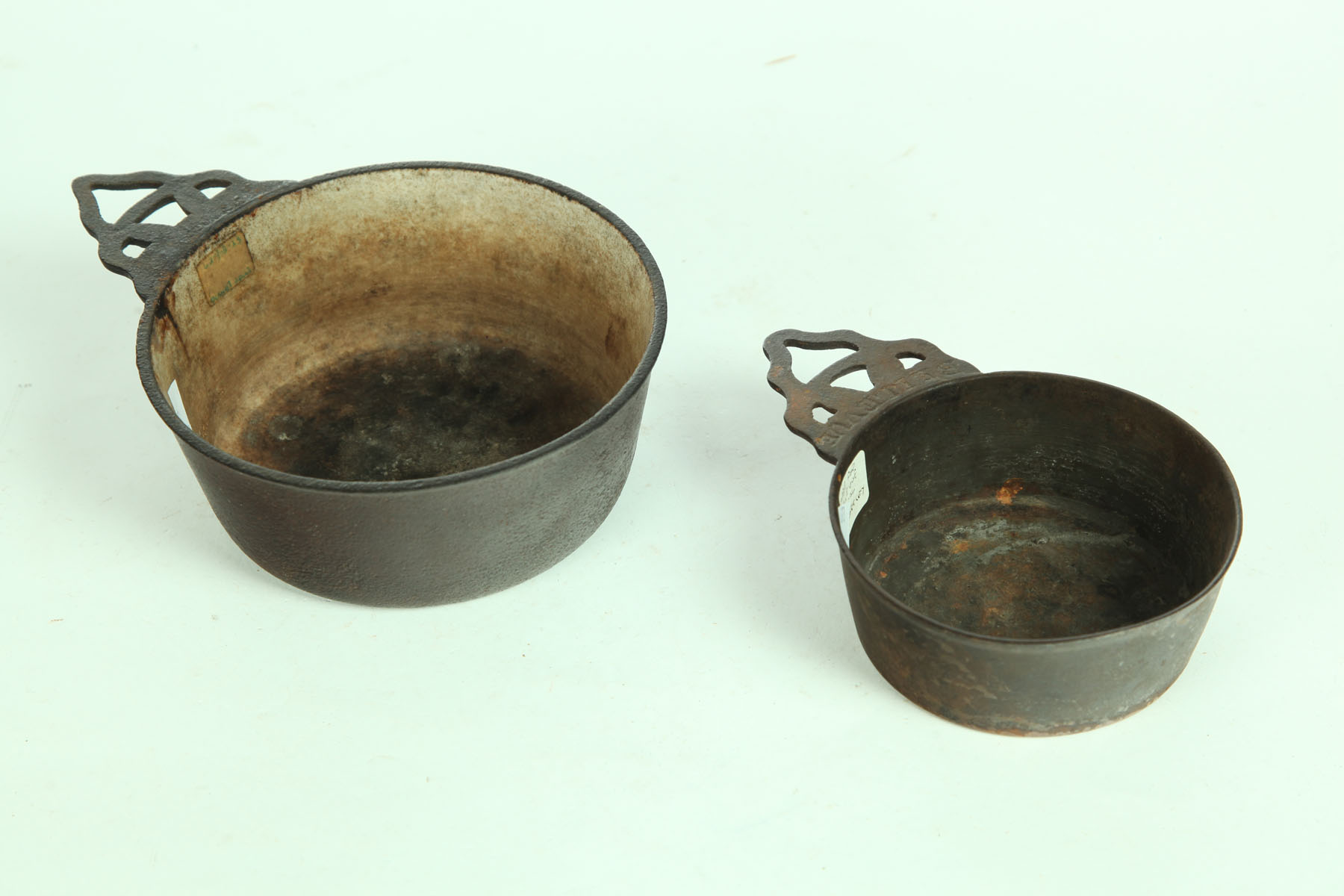 Appraisal: TWO CAST IRON PORRINGERS American th century One marked ''Clark