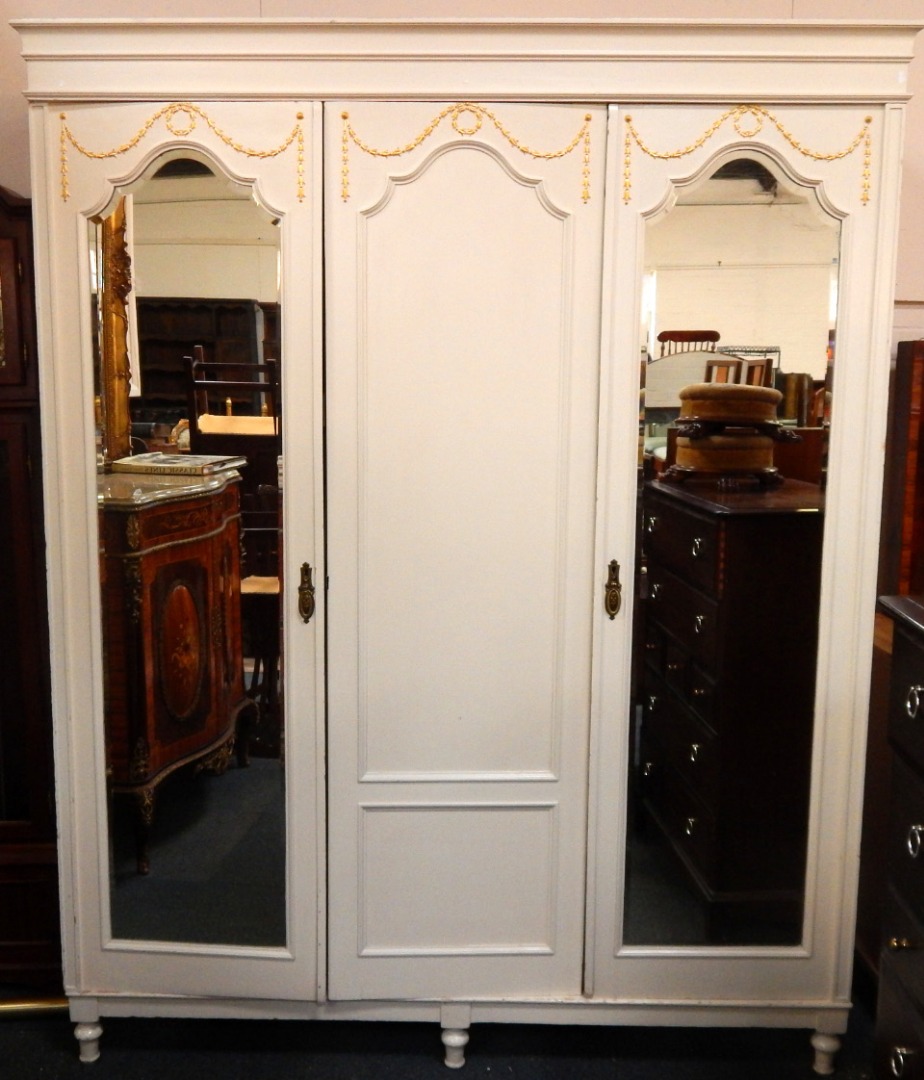 Appraisal: An Edwardian white painted triple section linen press with a