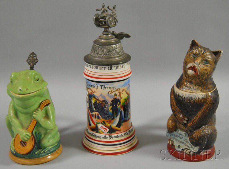 Appraisal: Three German Figural and Ornamental Steins two figural pottery frog