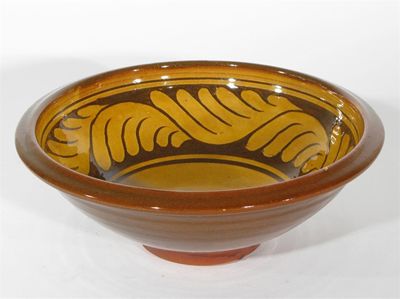 Appraisal: A St Ives earthenware bowl slip decorated with a stylised