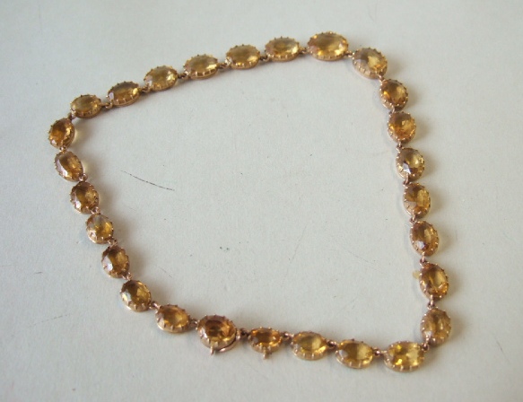 Appraisal: A gold and citrine necklace mounted with a row of