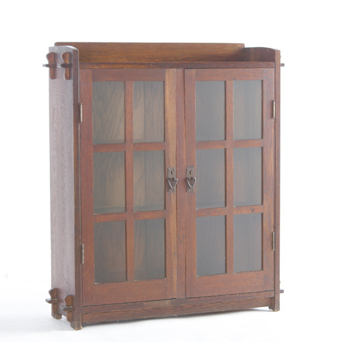 Appraisal: GUSTAV STICKLEY Two-door bookcase with six panes per door keyed