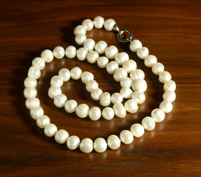 Appraisal: OPERA LENGTH WHITE PEARL NECKLACE strung with white baroque pearls