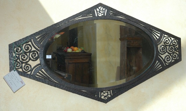 Appraisal: AN ART DECO WROUGHT IRON FRAMED WALL MIRROR The bevelled