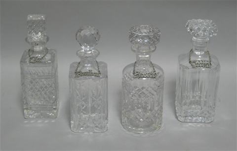 Appraisal: FOUR GLASS DECANTERS AND LABELS Including three square and one