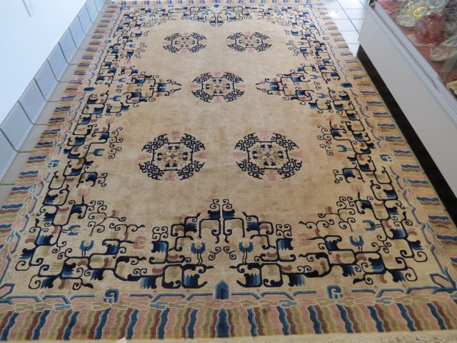 Appraisal: Chinese Handmade Rug deco style disc designs om light tan