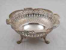 Appraisal: A pierced silver nut dish on three cast feet by