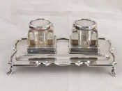 Appraisal: A silver inkstand with two cut glass silver mounted inkwells