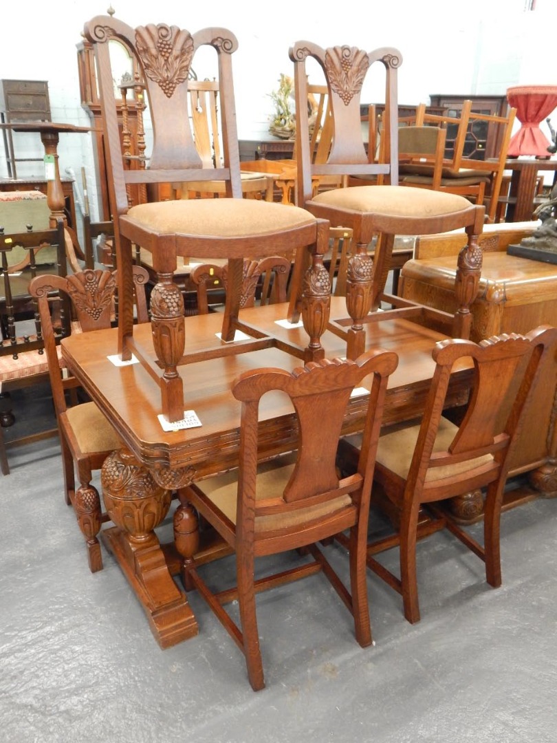 Appraisal: An associated oak dining room suite comprising a drawer leaf