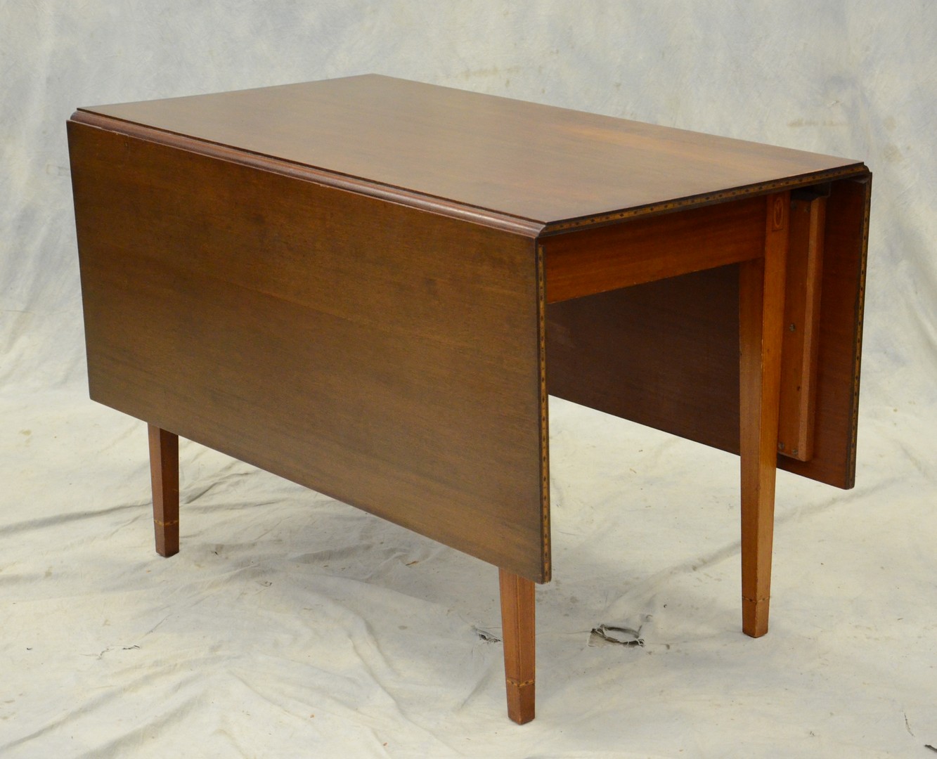 Appraisal: Inlaid walnut Hepplewhite style drop leaf dining table by Everett