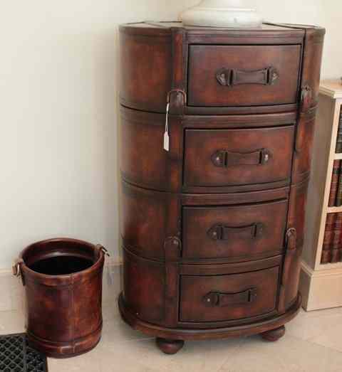 Appraisal: AN OVAL LEATHER COVERED CHEST of four drawers with belt