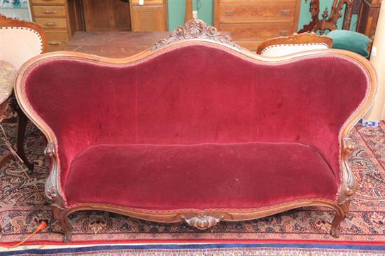 Appraisal: VICTORIAN SOFA Walnut with carved shell and rose decoration and